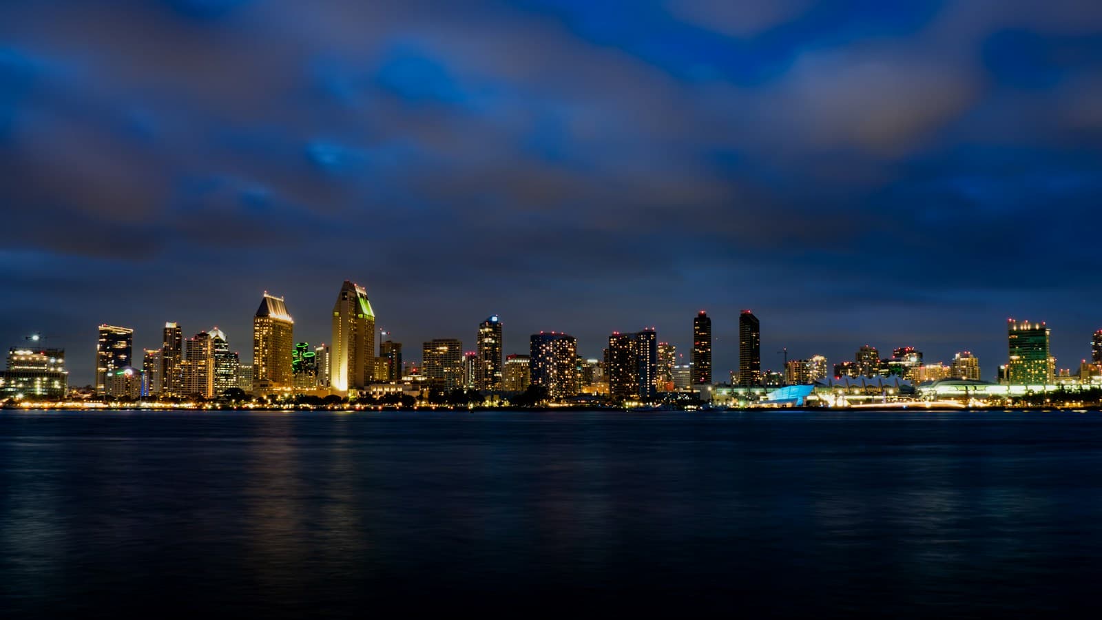 San Diego skyline illuminated across the bay at blue hour